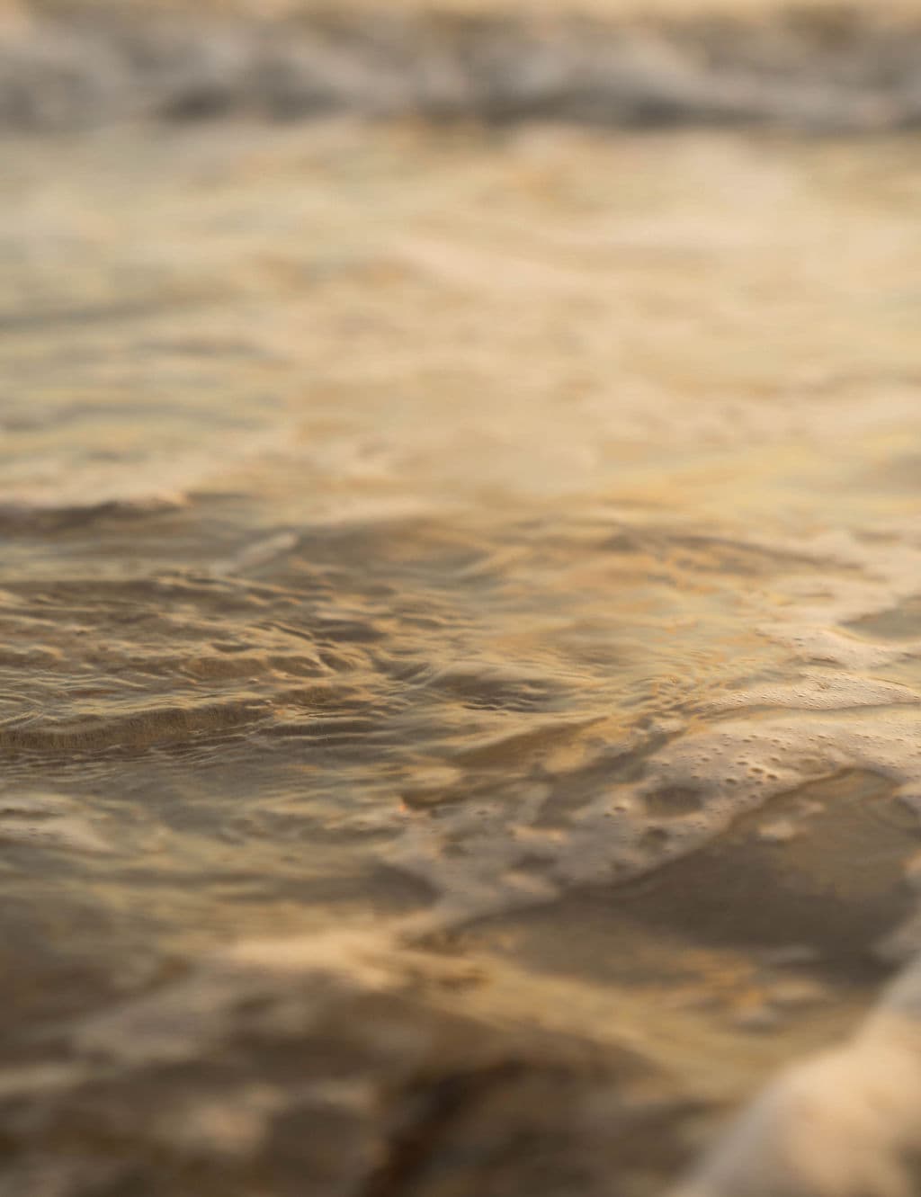 Close view of calm ocean water at sunset