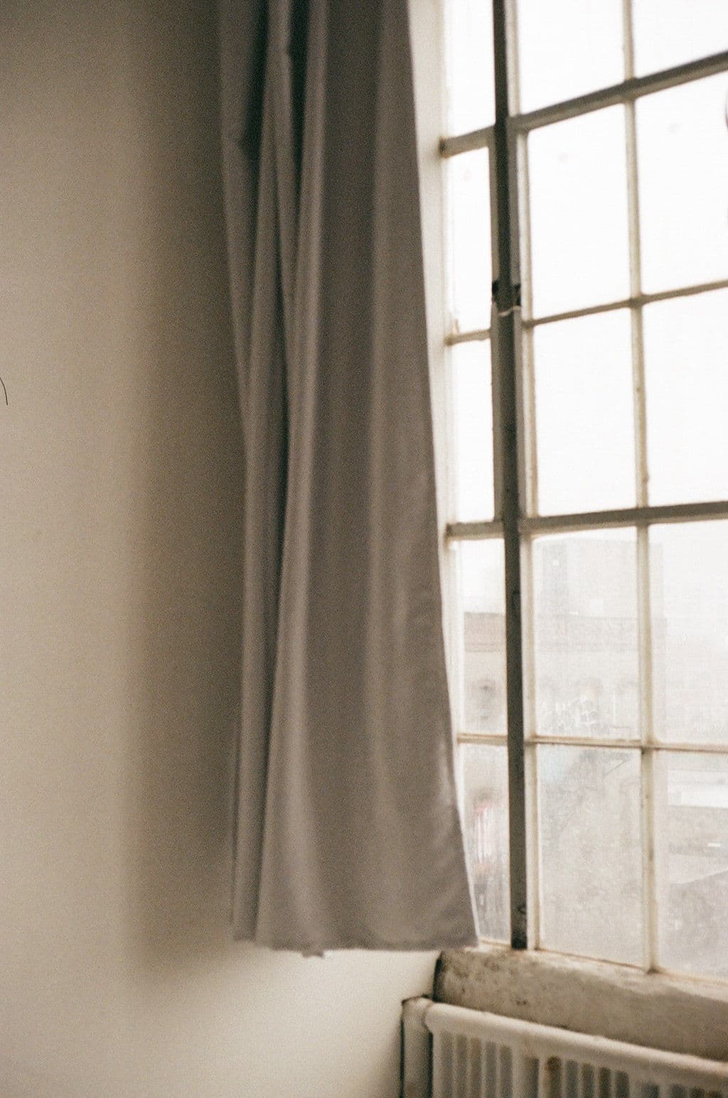 Soft daylight through a window with neutral curtains