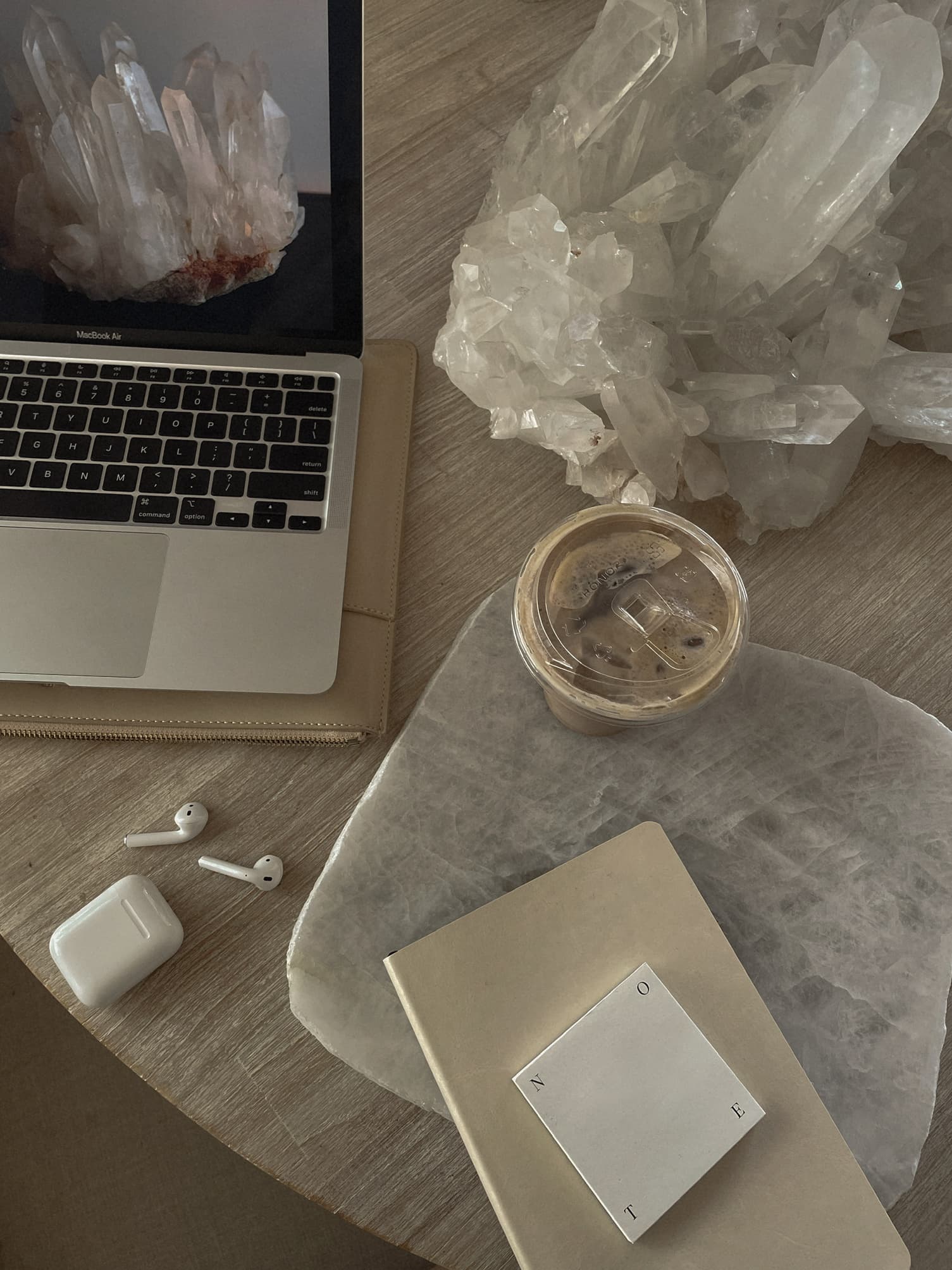 Laptop, notebook and crystals on a desk